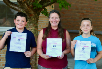 Students Jayke Williamson and Myra Hartings pictured with McGuffey Principal Cindy Baker