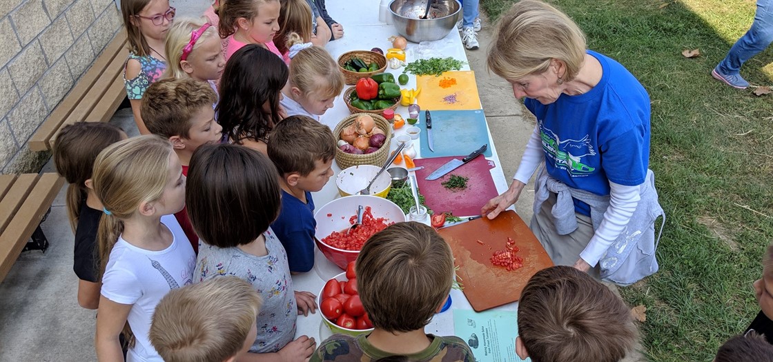 Mrs. Cooper shows students how to make salsa for the annual fall harvest day
